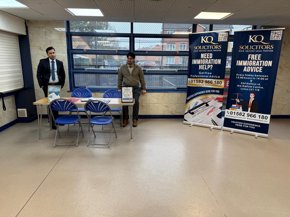 KQ Solicitors free immigration advice clinic setup at The Dallow Centre Luton showing advice table and branded banners